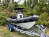 a boat on a trailer parked in the grass