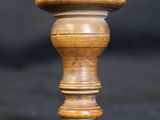a close up of a wooden knob on a black background