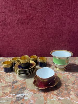 many cups and saucers sitting on a table