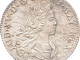 gros plan d'une pièce de monnaie sur laquelle figure une tête de femme