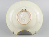 an image of a yellow and white plate with a tag on it