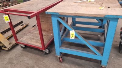 two tables that are sitting next to each other in a warehouse
