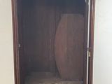 a wooden cabinet with a mirror on top of it