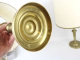 a person holding a brass object in their hand