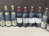 several bottles of wine are lined up on a table