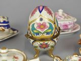 many different types of teapots and saucers on the table