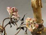 a bird that is sitting on a branch of a chandelier
