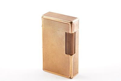 a gold lighter that is sitting on a white surface