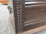 a very old wooden chest on the gravel ground