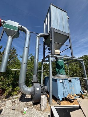 a large metal structure with pipes and a water tank