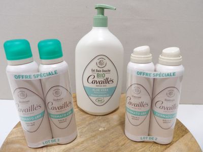several bottles of lotion sitting on top of a wooden board