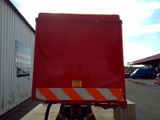 a red truck that is parked in front of a building