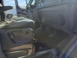 the interior of a truck with the door open and the driver ' s seat down