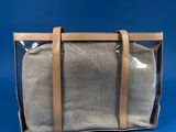 the bag is sitting on a blue surface with a blue background