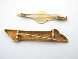 pair of antique gold tone hair clips with a bow and arrow