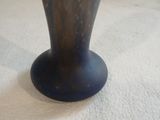 a blue vase that is sitting on a white surface