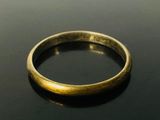a close up of a gold ring on a black surface