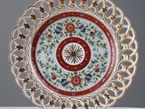 an image of a decorative plate on a table with a clock in the center