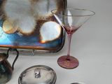 a silver tray with a glass and a silver tray with a wine glass and a silver tray with a wine glass and a silver tray with a wine glass