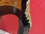 a black and gold table with a red wall in the background