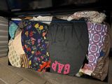 a suitcase full of clothes that is sitting on the floor