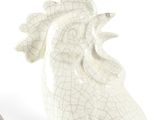 a white ceramic rooster figurine sitting on a white surface