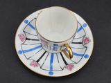 a cup and saucer on a saucer on a table