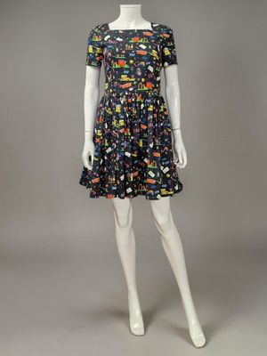 a mannequin dressed mannequin wearing a black and multicolored dress