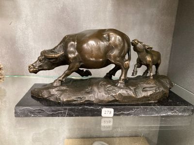 a bronze statue of a bull and a baby bull