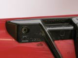 a close up of a red car with a black handle