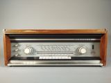 an old radio sitting on top of a wooden table