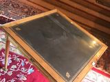 a small table with a black leather top on a red rug