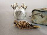 a small silver bottle and a small silver bottle on a table