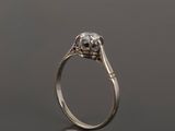 a white gold engagement ring with a round brilliant cut diamond