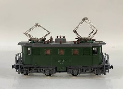 a green train on a white surface with a white background