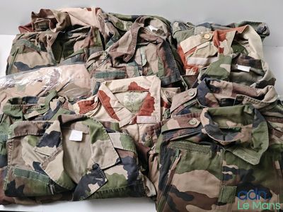a pile of camouflage clothing on a white table