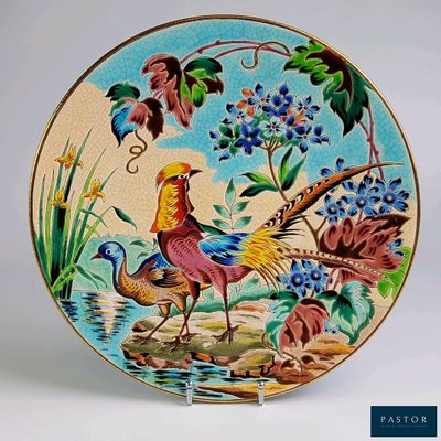 a decorative plate with a bird and flowers painted on it