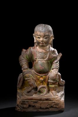 an image of a statue of a person sitting on a rock