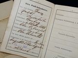 several old papers with writing on them on a table