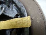 a close up of a helmet with a yellow strap