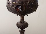 a silver bowl with a bird on it on a table
