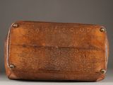 an old brown leather purse with a metal clasp on the front