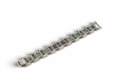 a close up of a bracelet on a white surface