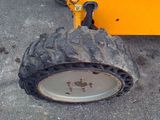 a tire that is sitting on the ground next to a plow