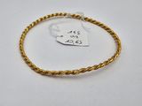 a gold rope bracelet with a price tag on it
