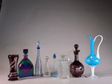 many different colored glass vases and vases on the table