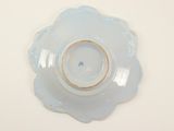 a blue plate with a gold rim on a white table