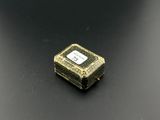 a close up of a small black and gold box on a black surface