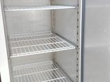 an empty refrigerator that is sitting in the corner of the room