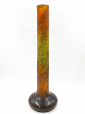 a glass vase with a green and orange design on it